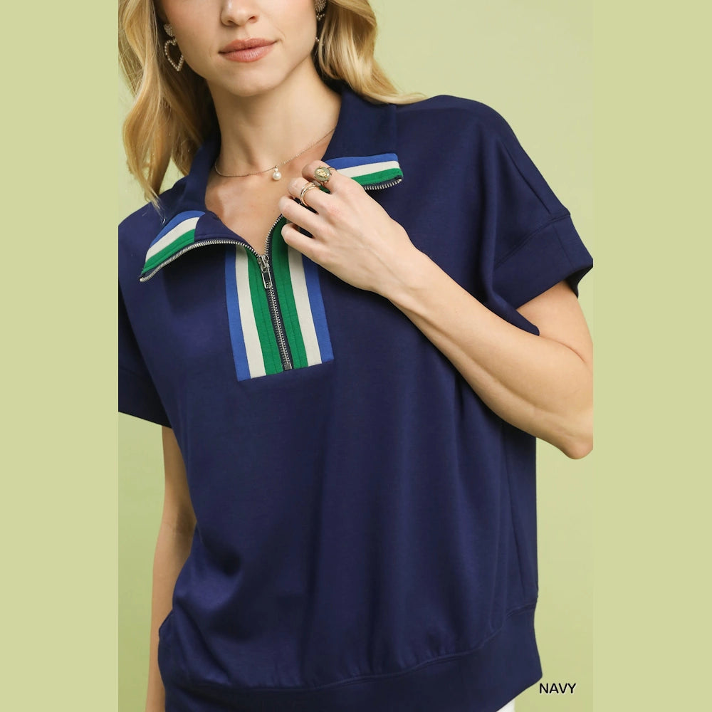 Navy short-sleeve half-zip knit top with green, white, and blue striped collar and placket detailing.