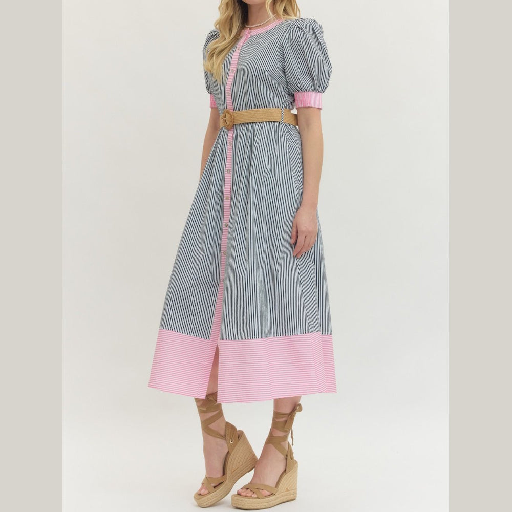 Side view of a striped puff-sleeve midi dress with pink accents and a tan waist belt paired with platform wedge sandals.