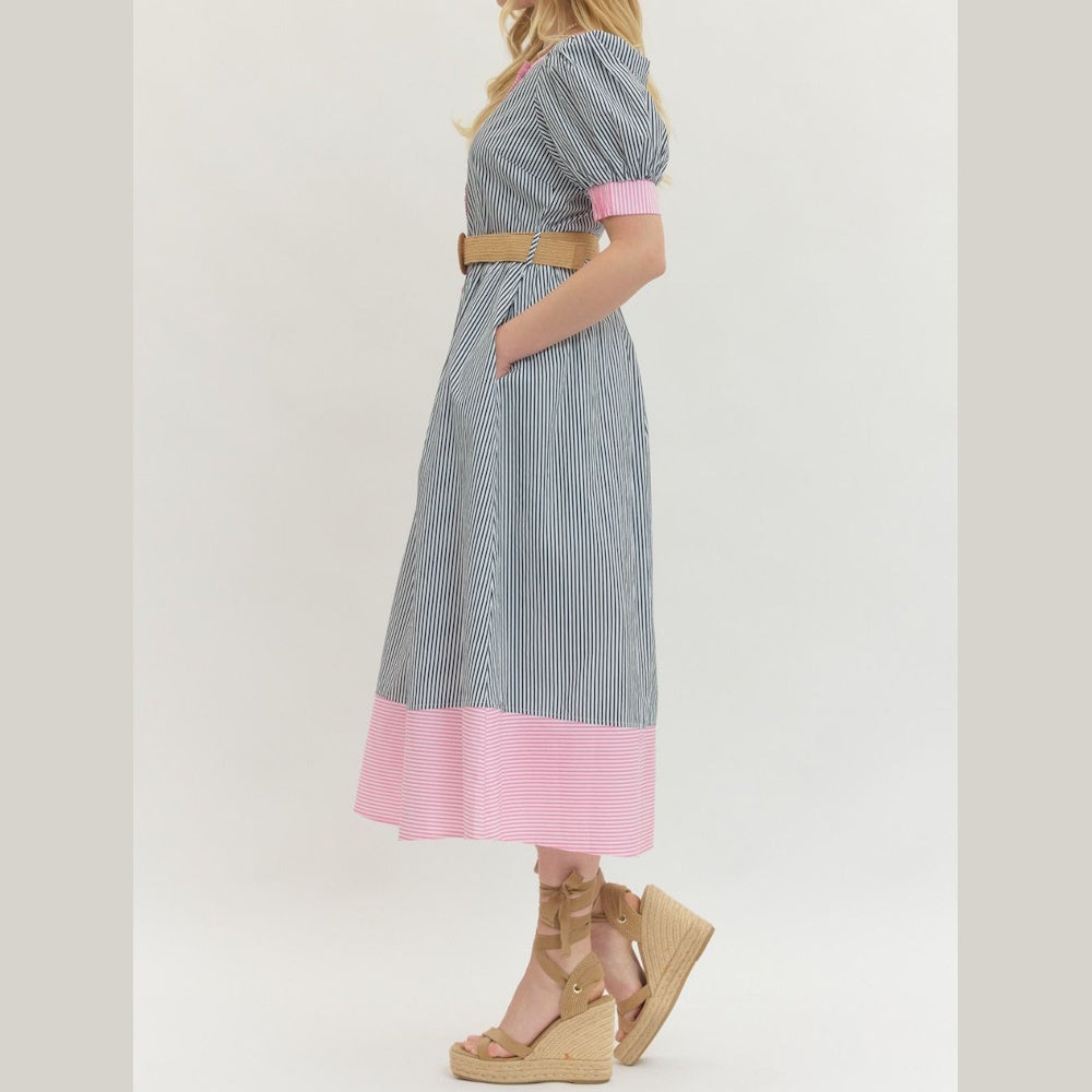 Side view of a striped puff-sleeve midi dress with pink hem, tan belt, and platform wedge sandals.
