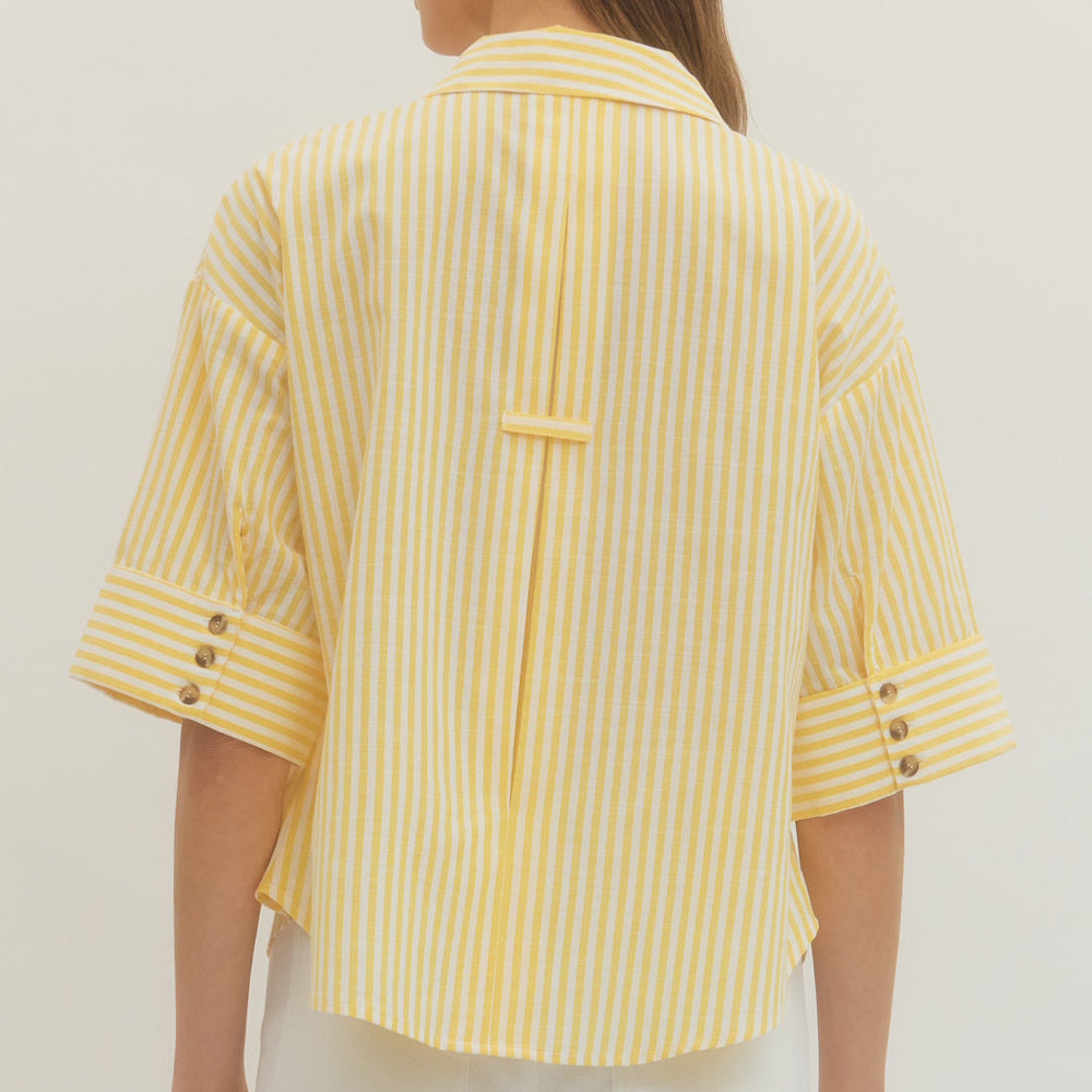 Back view of a yellow and white striped shirt with three-quarter sleeves and button details.