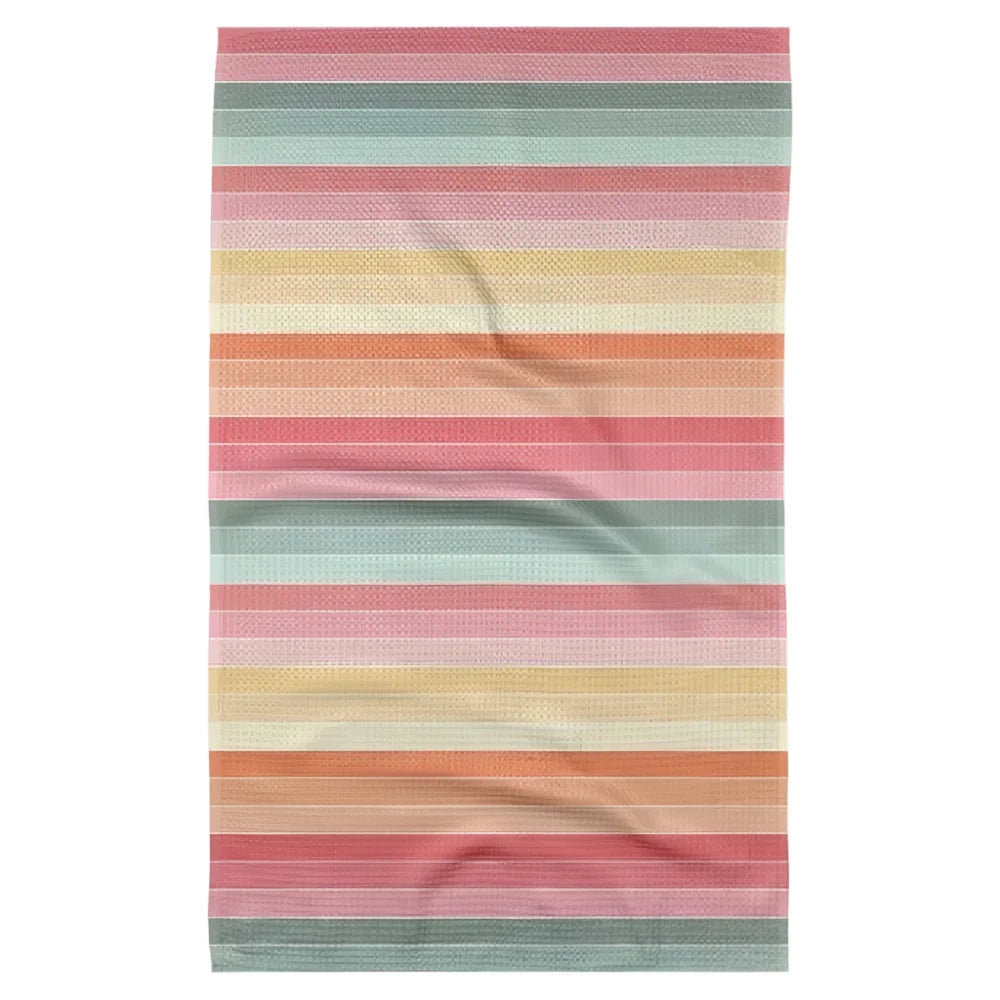 A tea towel with a pattern of horizontal stripes in pink, orange, yellow, and sage green pastel colors.