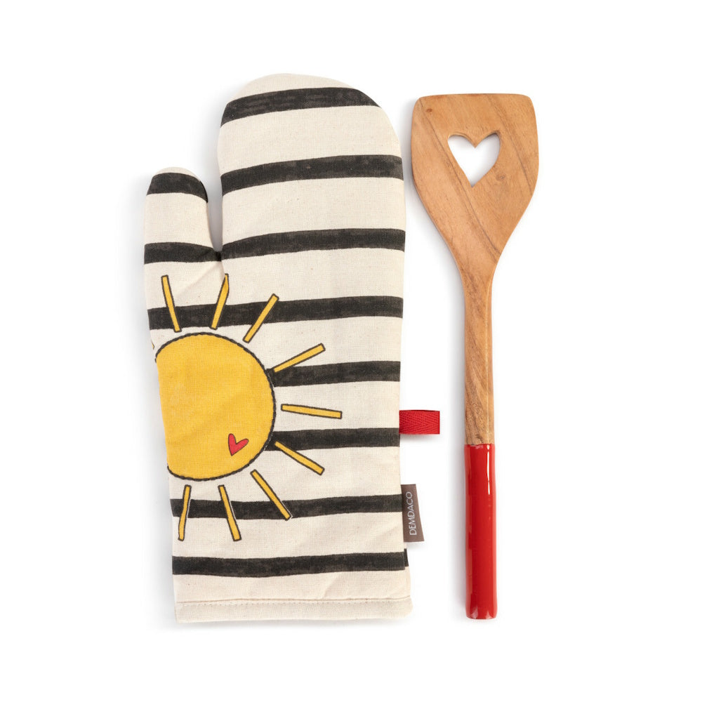 A striped oven mitt with a sun graphic next to a wooden spatula featuring a heart cutout.