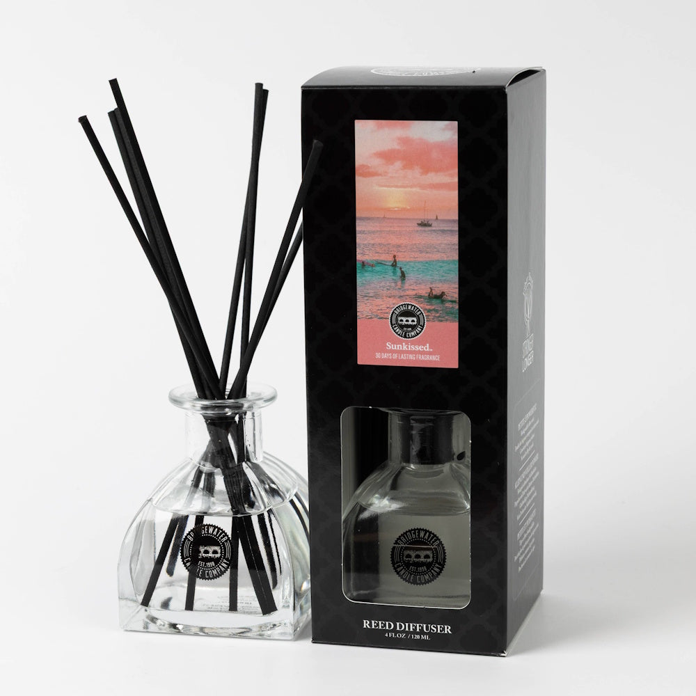 Sunkissed scented reed diffuser in glass bottle with black reeds and black decorative packaging box.