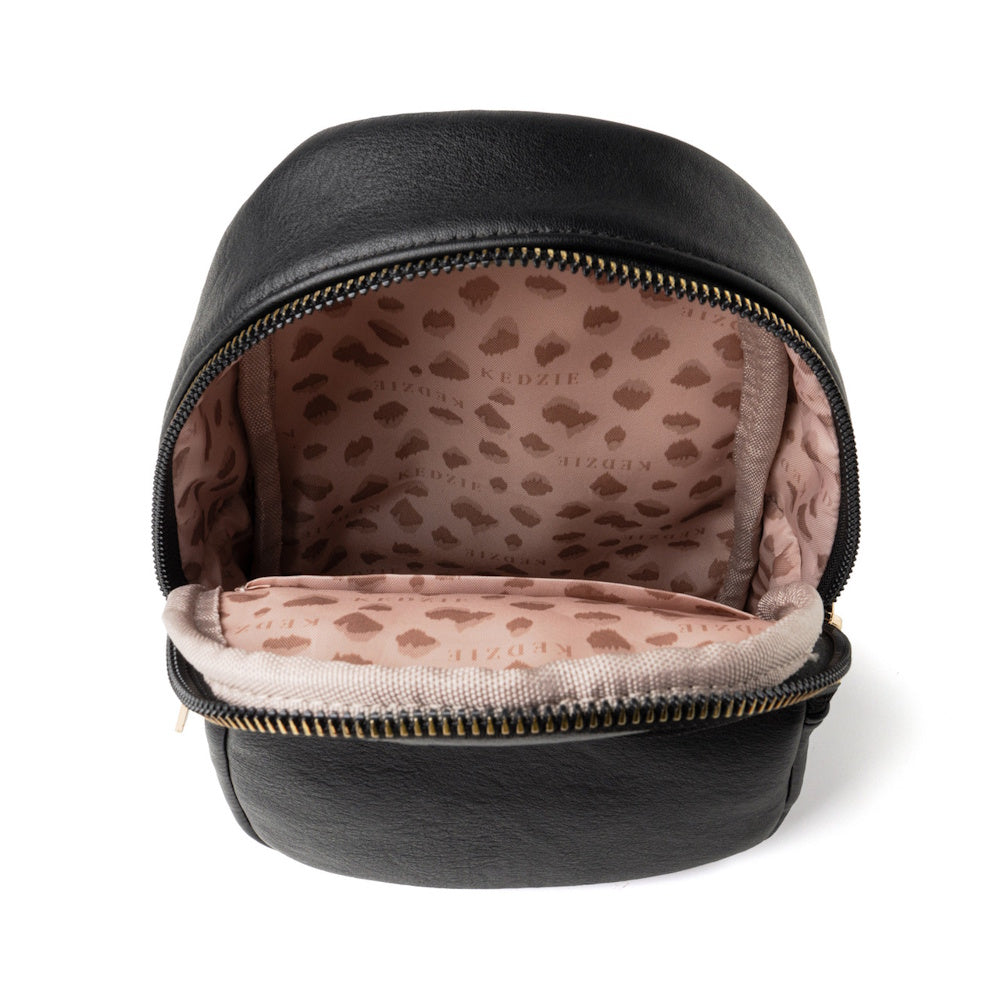 Open black Kedzie bag showing a pink leopard print fabric interior lining on white background.