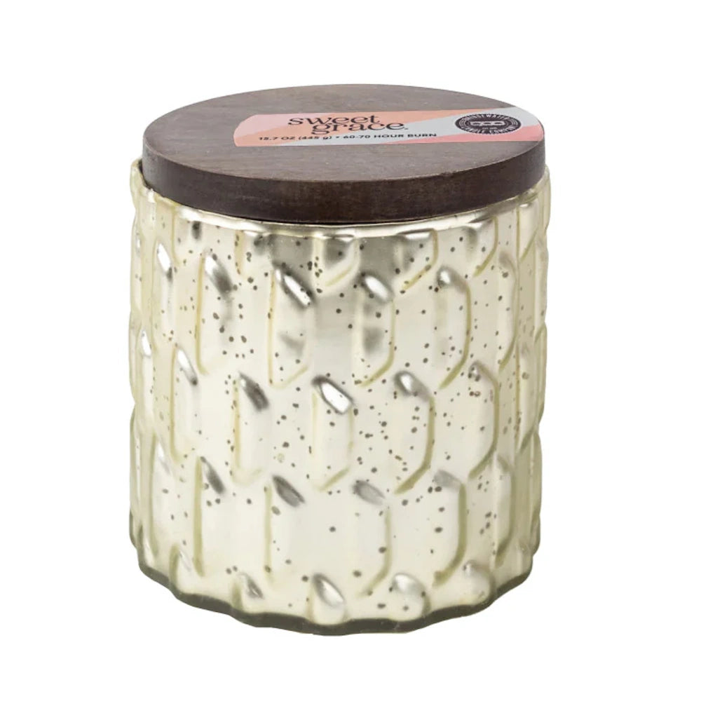 A textured, silver mercury glass candle jar with a dark wooden lid and a pink label reading "Sweet Grace."