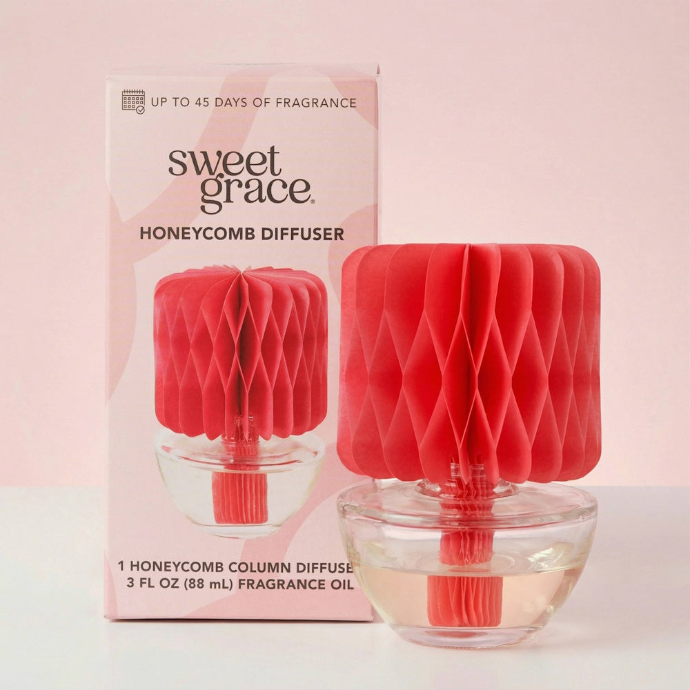 Sweet Grace Honeycomb Diffuser next to its packaging, featuring a red paper topper and clear glass base.