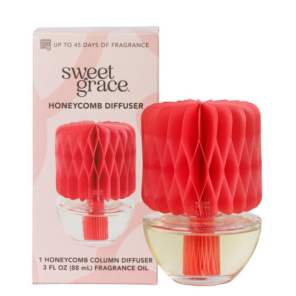Sweet Grace Honeycomb Diffuser in a glass vessel with coral paper topper, set beside its original box.