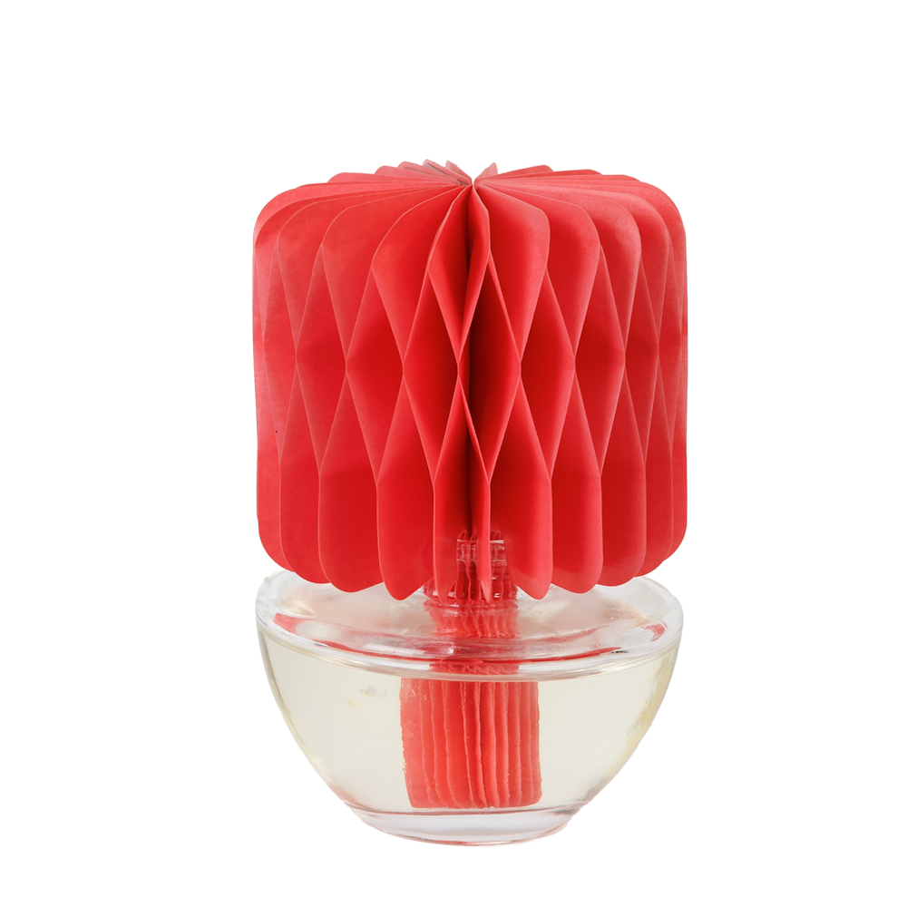 Red paper honeycomb flower diffuser in a rounded clear glass jar with fragrance oil.