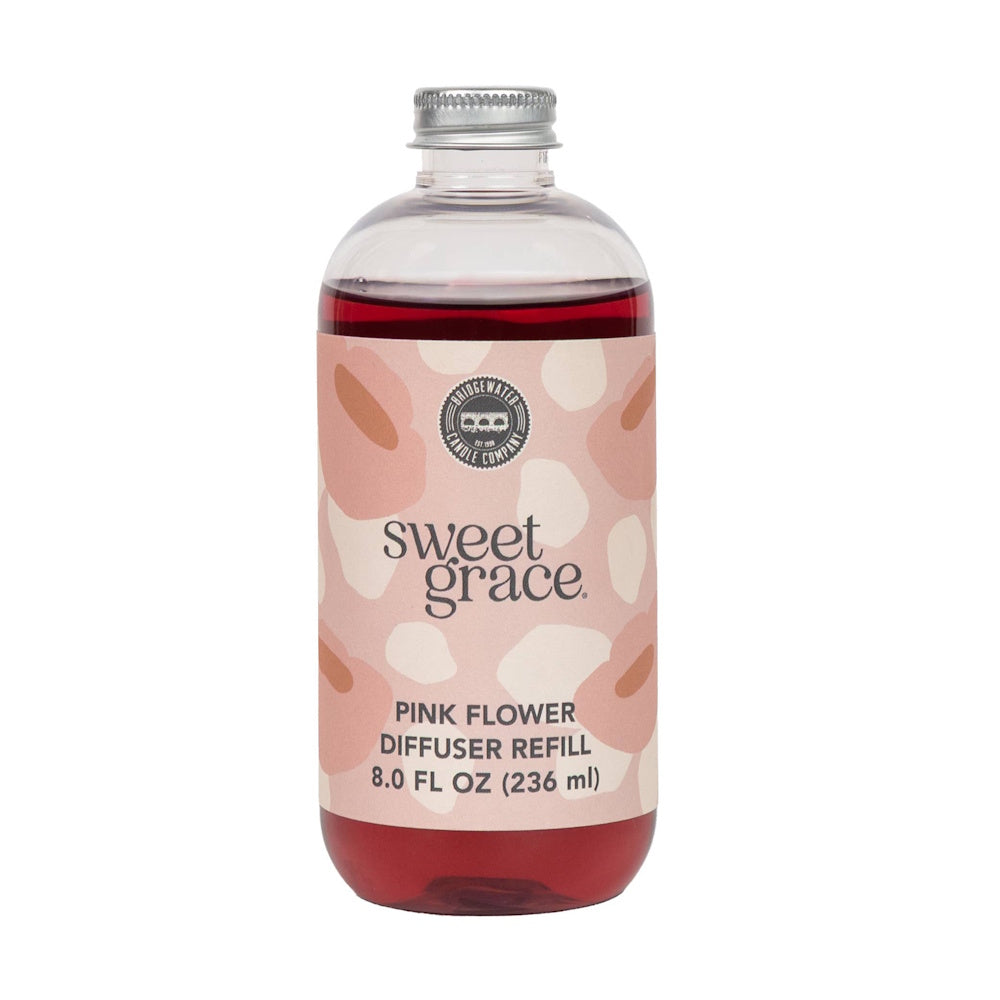 Clear glass bottle with silver cap filled with red liquid, featuring a patterned Sweet Grace label on white background.
