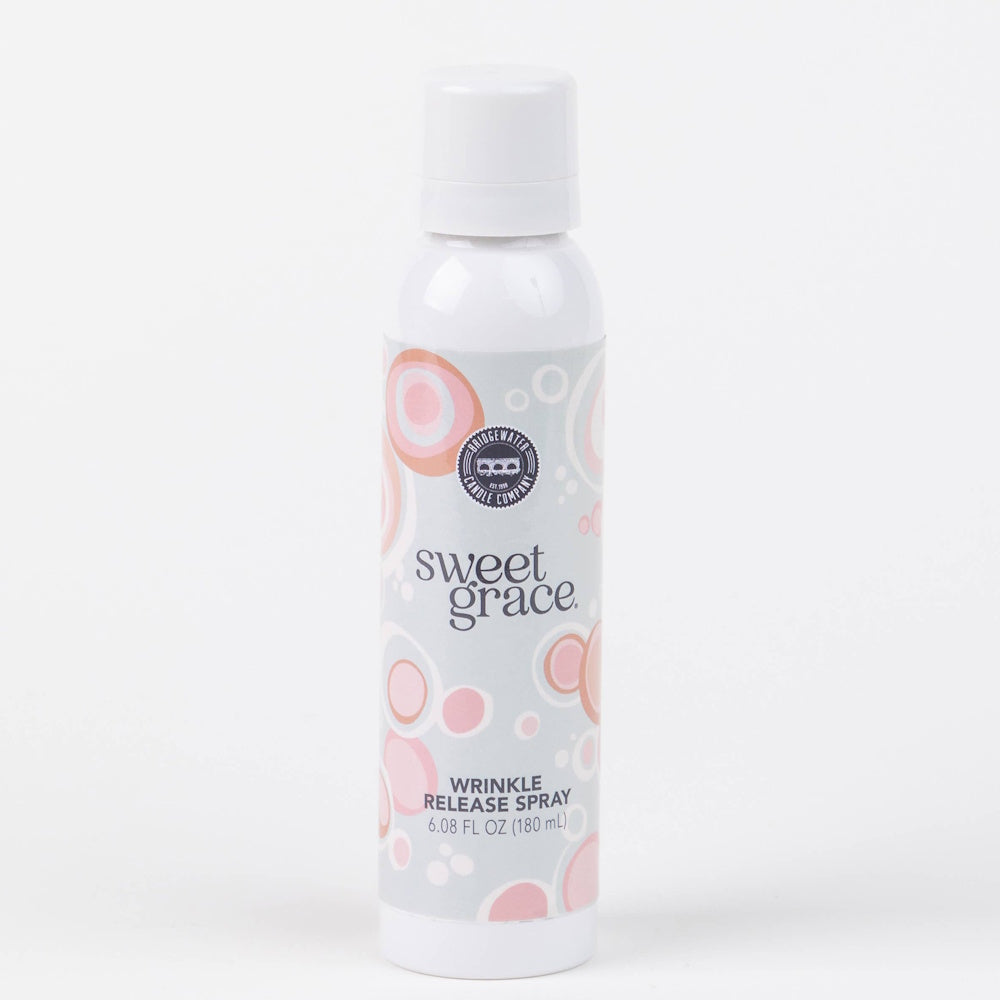 White spray bottle labeled "Sweet Grace Wrinkle Release Spray" with pink circle accents.