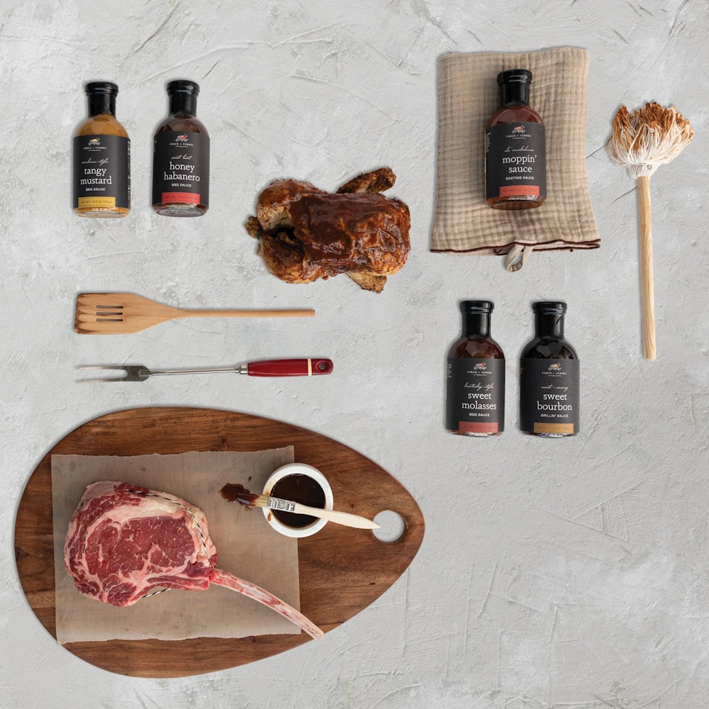 Assorted Finch + Fennel BBQ sauces, including Apple Cinnamon and Sweet Bourbon, with tasting samples and a basting mop.