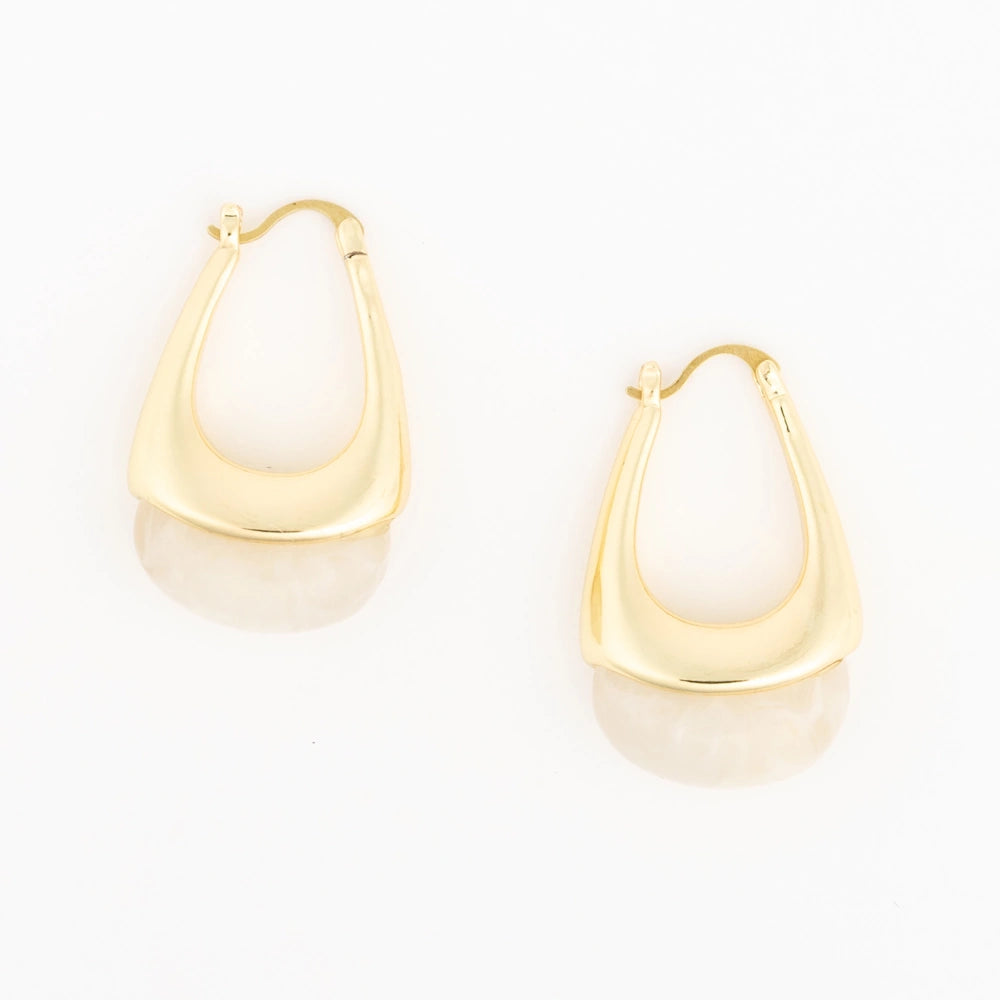 Pair of gold teardrop hoop earrings with cream resin bottoms on a plain white background.