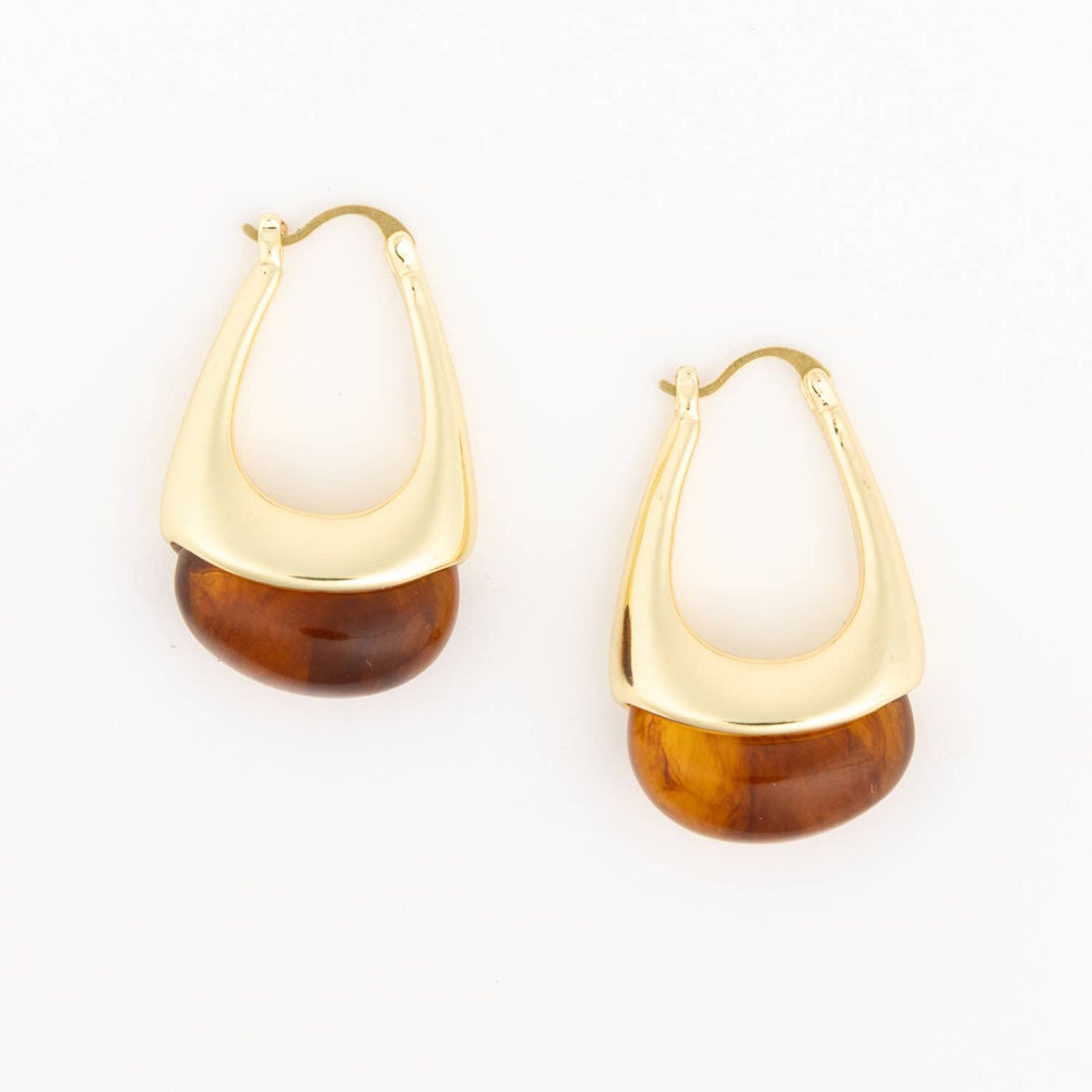 Pair of gold teardrop hoop earrings with tortoiseshell resin bottoms on a plain white background.