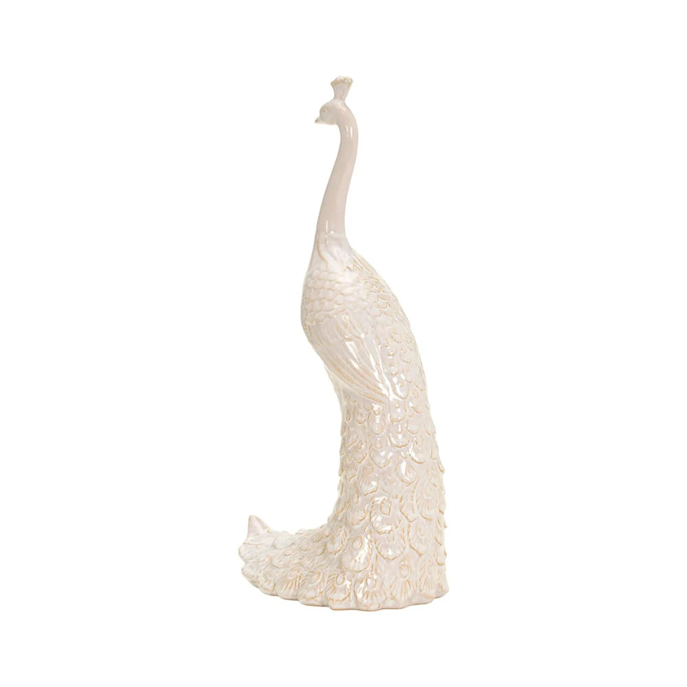 Side profile of an ivory peacock ceramic figurine with intricate feather detailing and subtle gold accents.