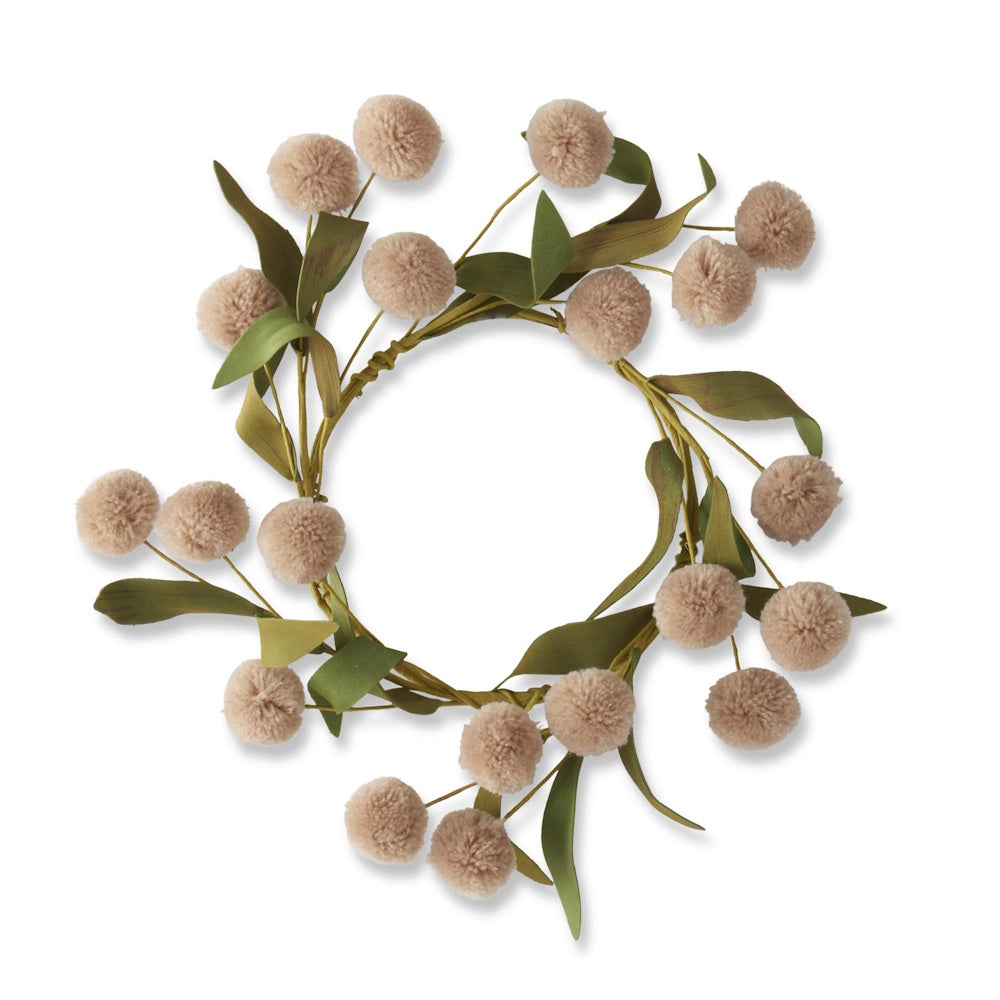 A circular wreath featuring beige pom-poms and green leaves against a plain white background.