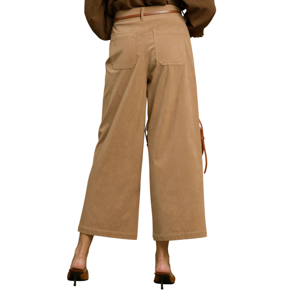 Back view of a person wearing taupe wide-leg corduroy pants with back patch pockets and a narrow belt.