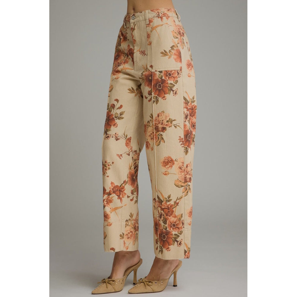 Three-quarter view of taupe floral print wide-leg pants highlighting front patch pockets and seams.