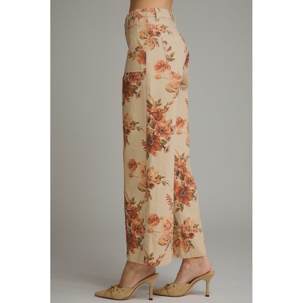 Side profile view of taupe wide-leg pants featuring a warm brown floral print and patch pocket detail.