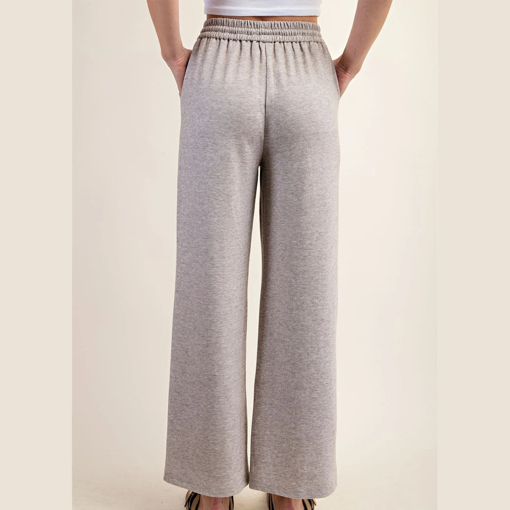 Taupe wide-leg knit pants with a high elastic waistband and back view on a model.