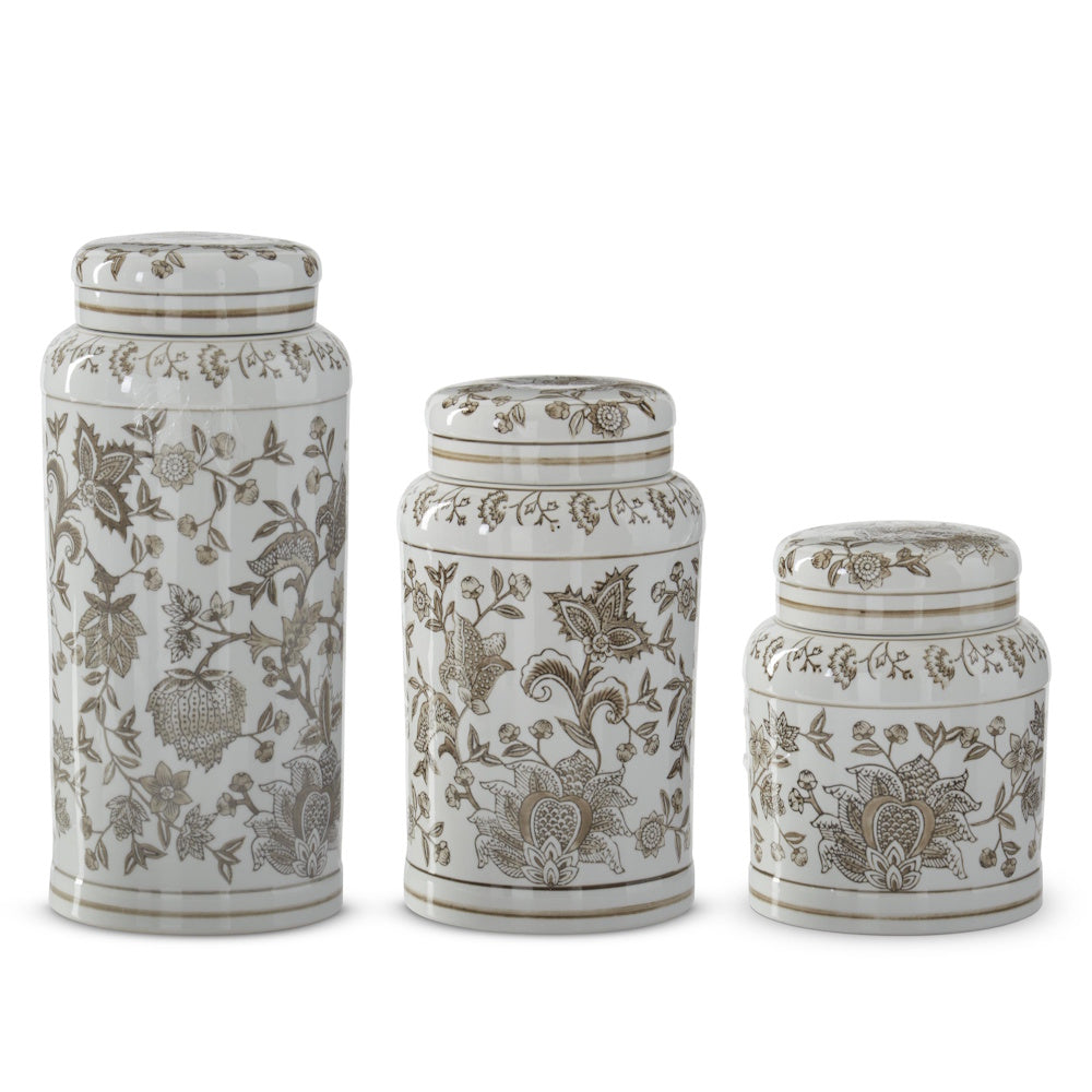 Set of three taupe and white porcelain chinoiserie lidded jars in varying sizes with floral patterns.