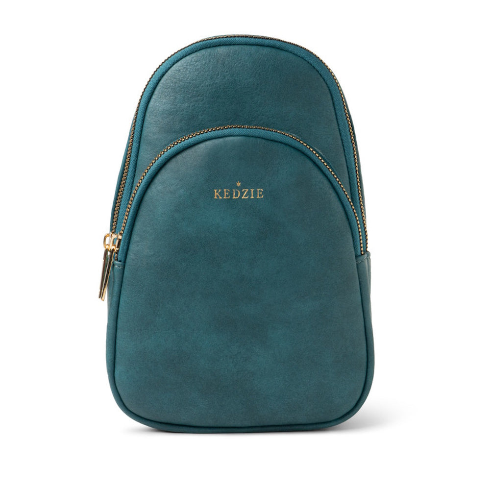 A teal green Kedzie sling bag with gold zippers and a front pocket on a white background.