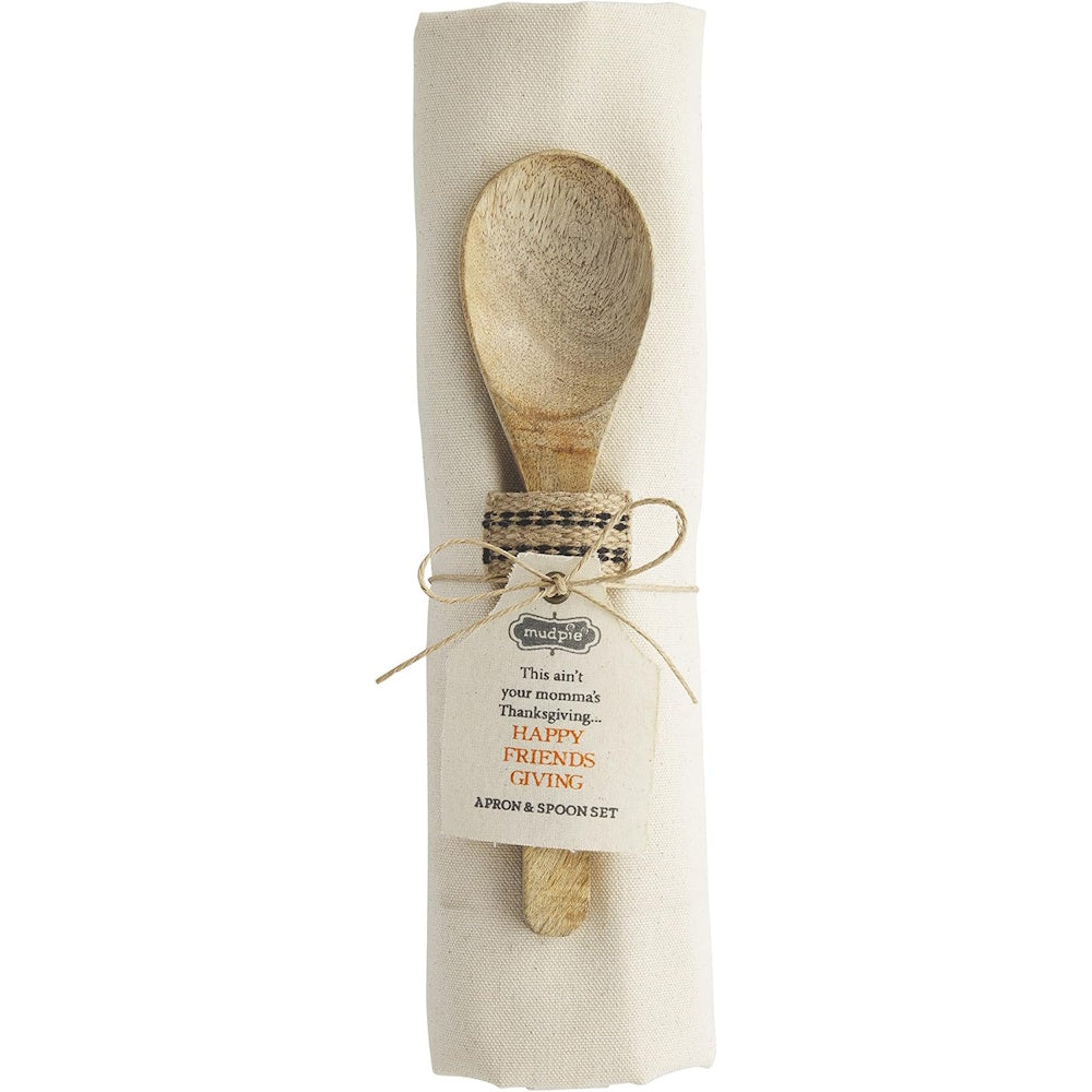 Rolled canvas apron tied with a wooden spoon and a "Happy Friendsgiving" gift tag.