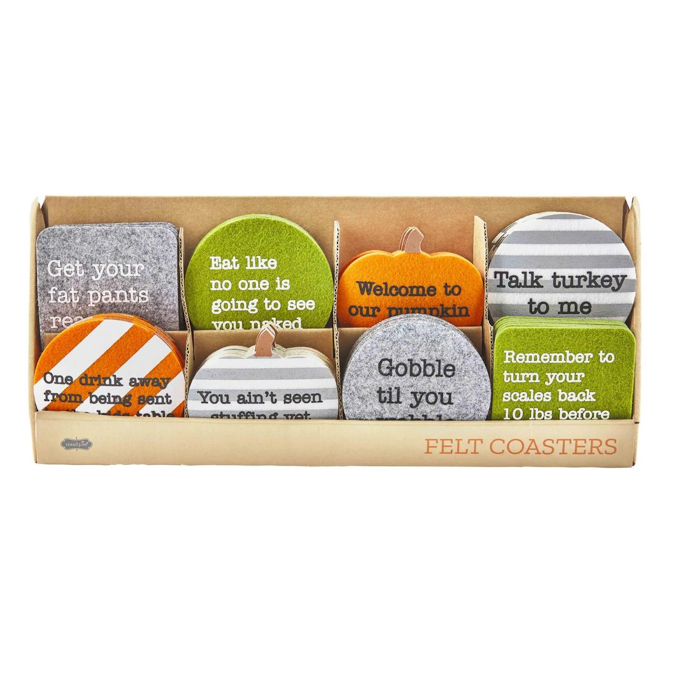 A display box filled with colorful Thanksgiving-themed felt coasters featuring funny seasonal phrases.