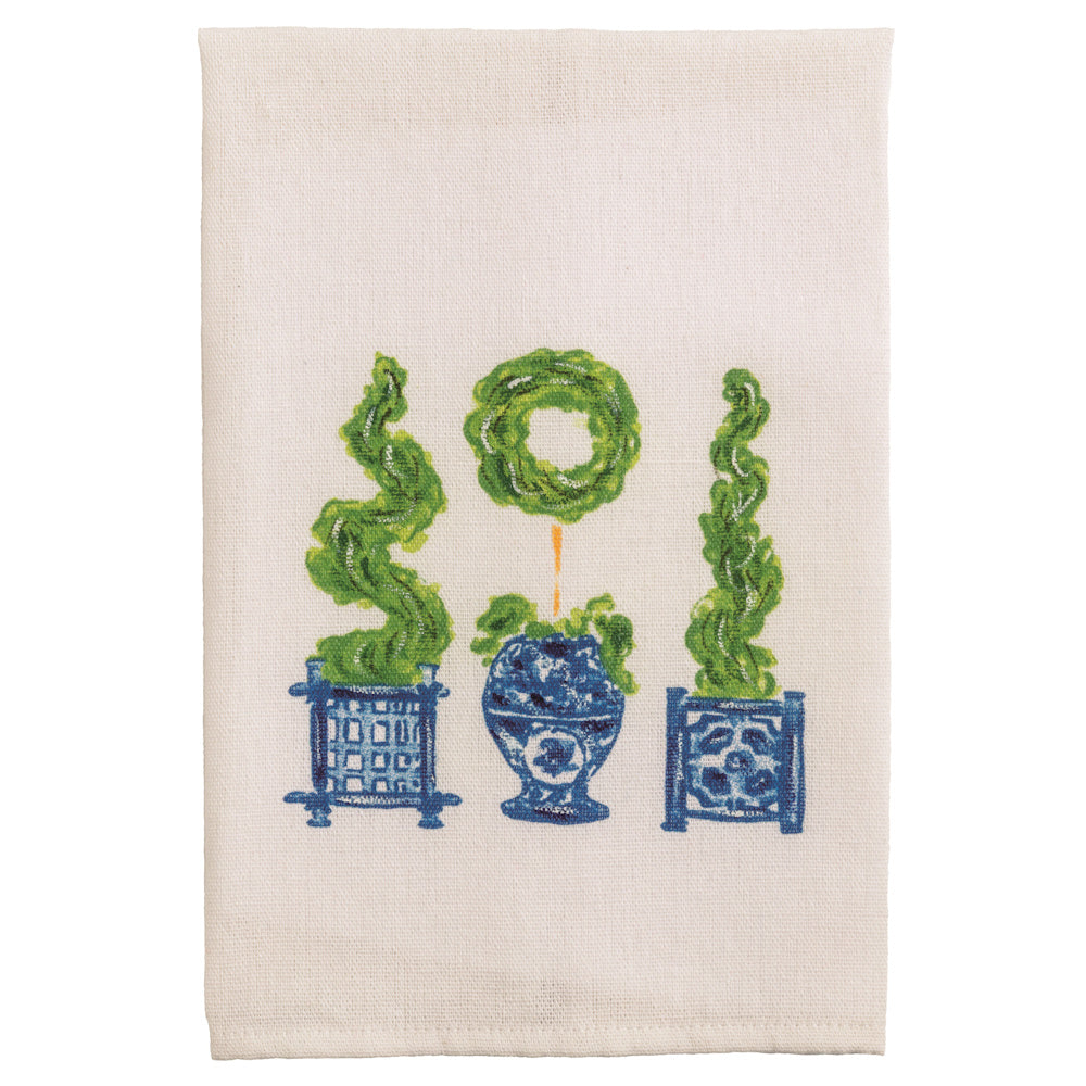 White linen tea towel with green topiary plants in blue and white Chinoiserie ginger jars and planters.