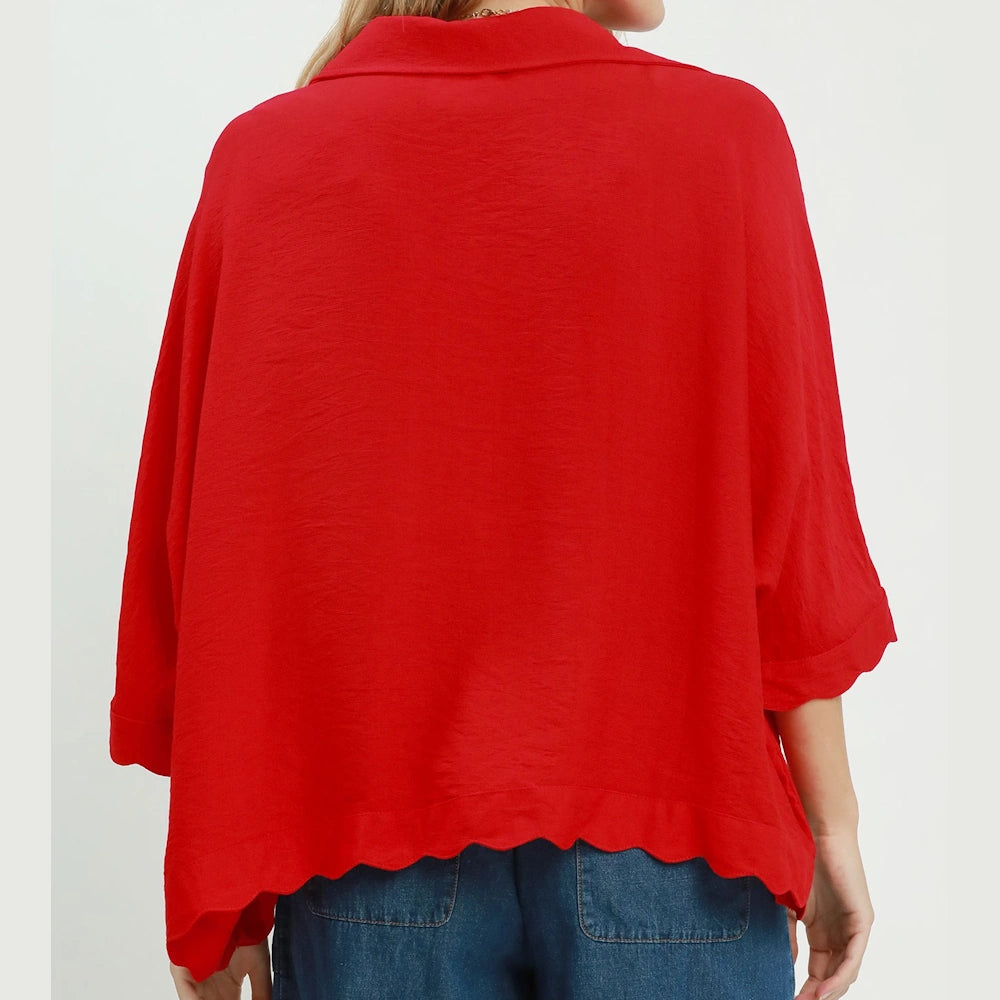 Back view of a tomato red collared top featuring an oversized fit and a scalloped hem.
