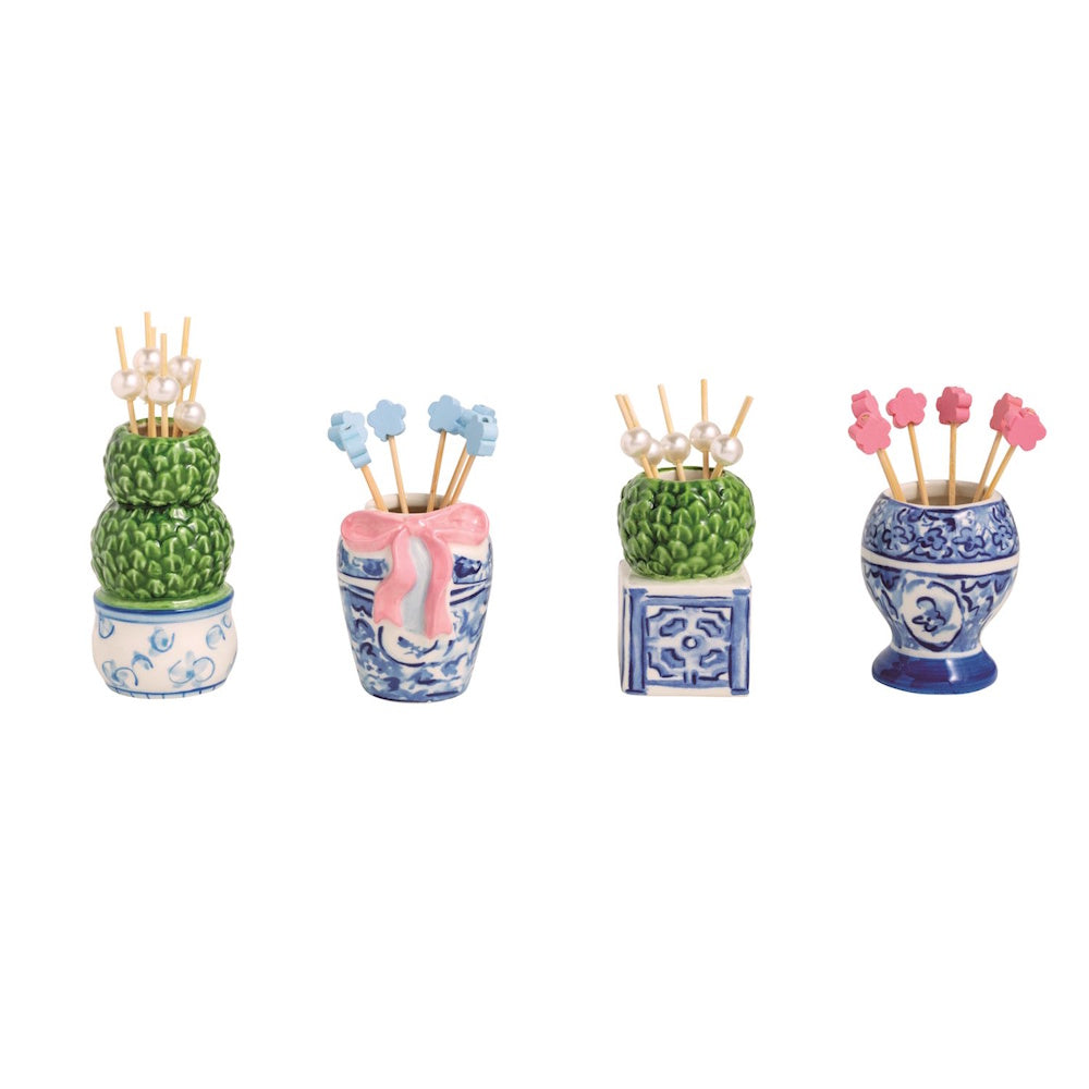 Four blue and white ceramic topiary toothpick holders with decorative floral and pearl picks on a white background.