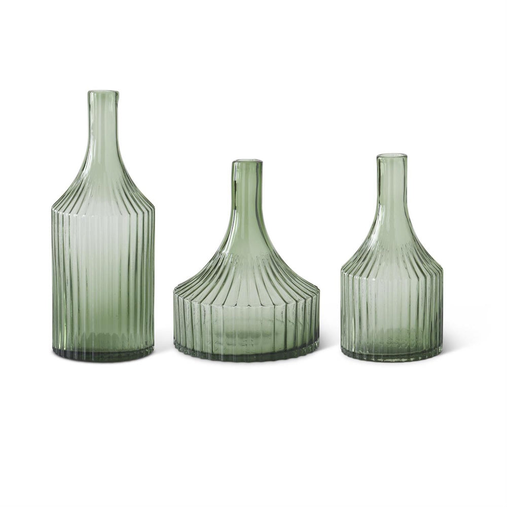 Set of three transparent green glass vases with vertical ribbed texture and narrow necks on a white background.