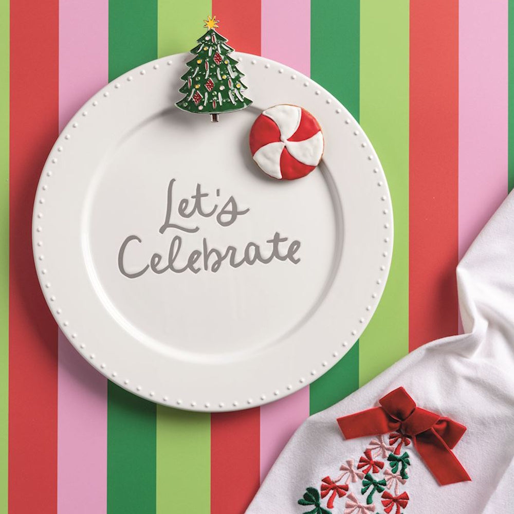 White Christmas plate with Let's Celebrate text, holiday tree charm, and peppermint candy.