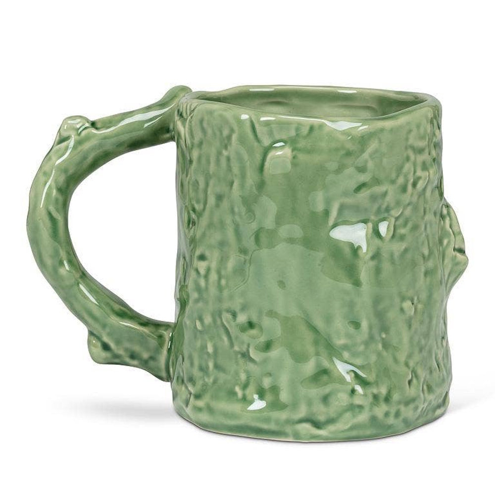 Green ceramic mug shaped like a textured tree trunk with a branch handle.