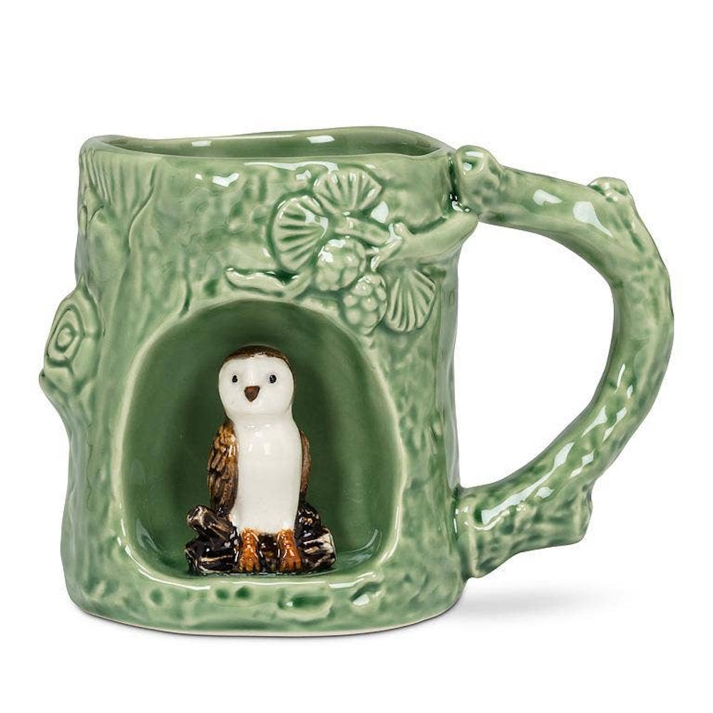 Green ceramic tree stump mug featuring a small barn owl figurine sitting inside a hollow.