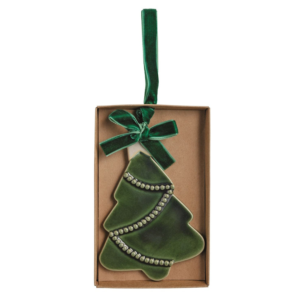 Green ceramic Christmas tree ornament with beaded garland and green velvet ribbon in a box.