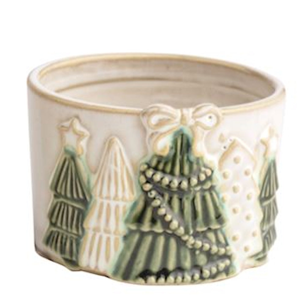 White ceramic dish with embossed green and cream Christmas trees and a bow detail.