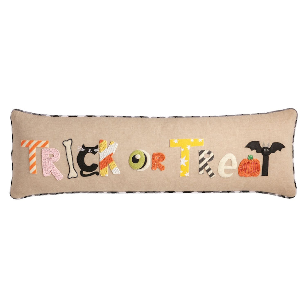 Long Halloween lumbar pillow featuring Trick or Treat spelled with festive shapes and textures.