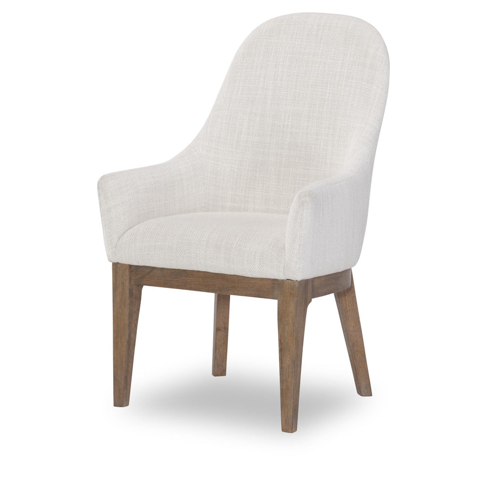 Modern cream upholstered dining chair with wooden legs and high backrest.