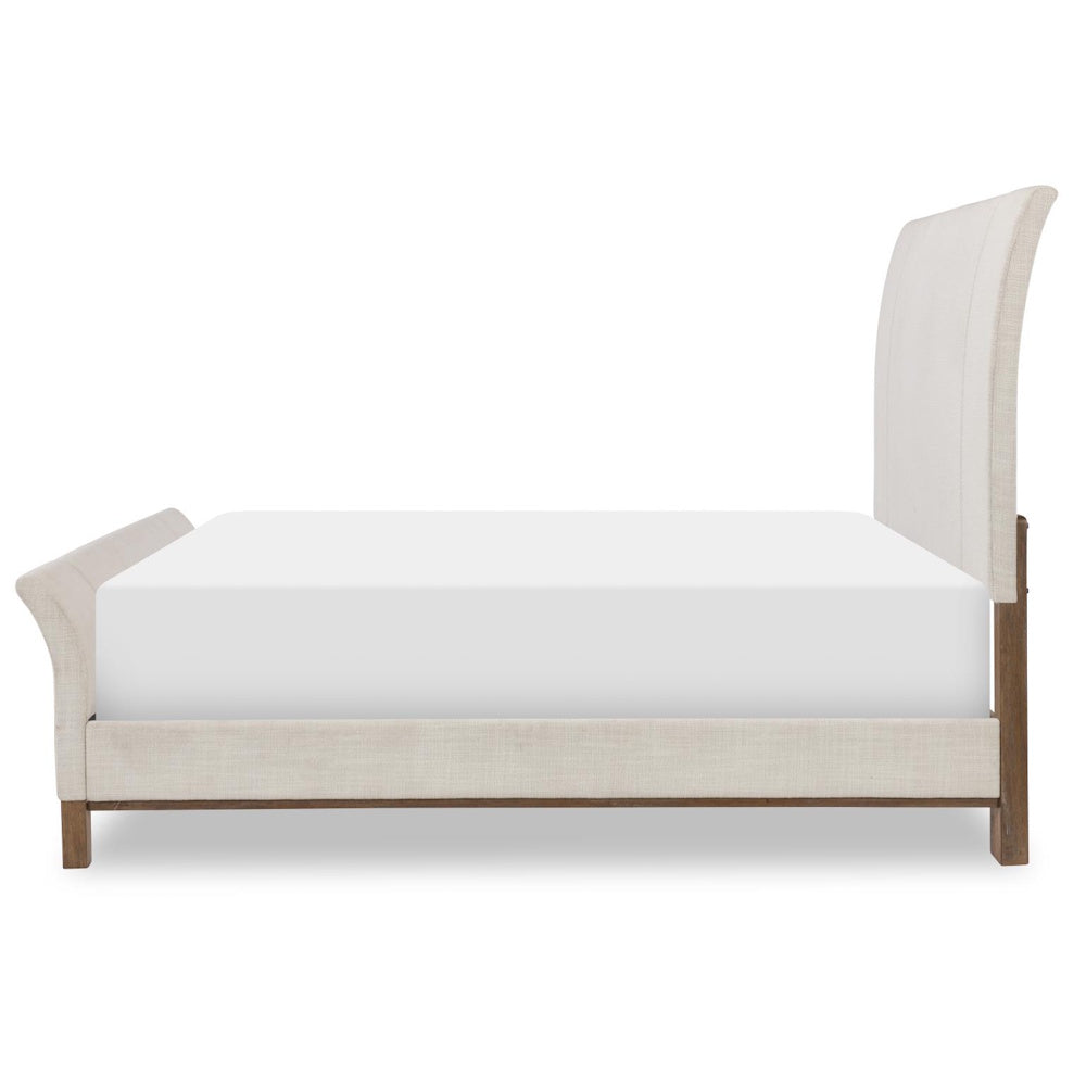 Modern upholstered sleigh bed with cream fabric and wooden frame.