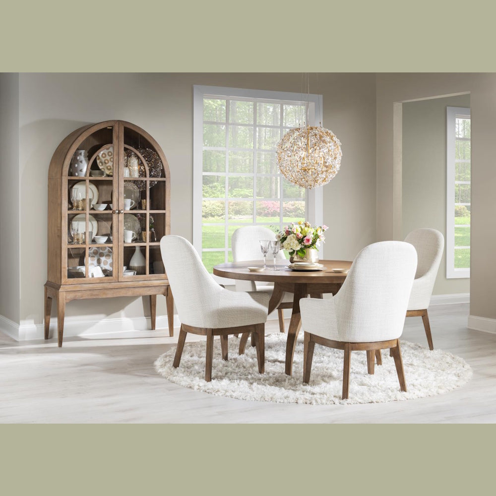 Modern wood dining set with white upholstered chairs, arched china cabinet, and globe chandelier.