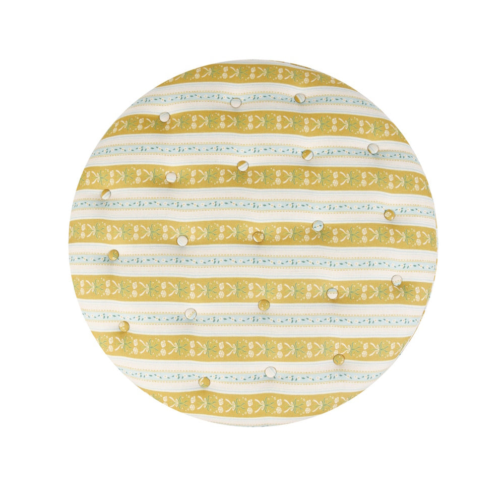 Top view of a round yellow and white striped tufted fabric upholstered ottoman.