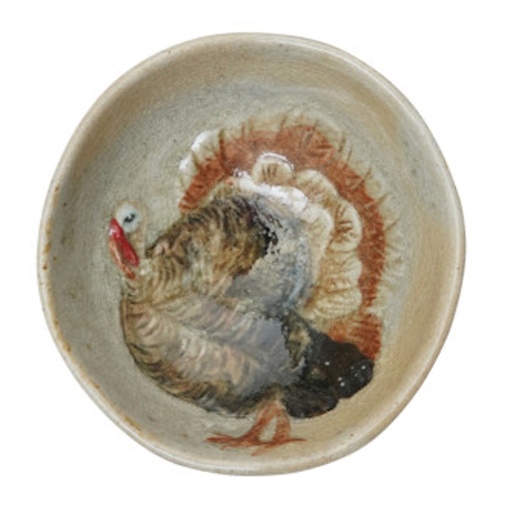 Hand-painted round stoneware dish featuring a turkey illustration with fanned tail feathers.