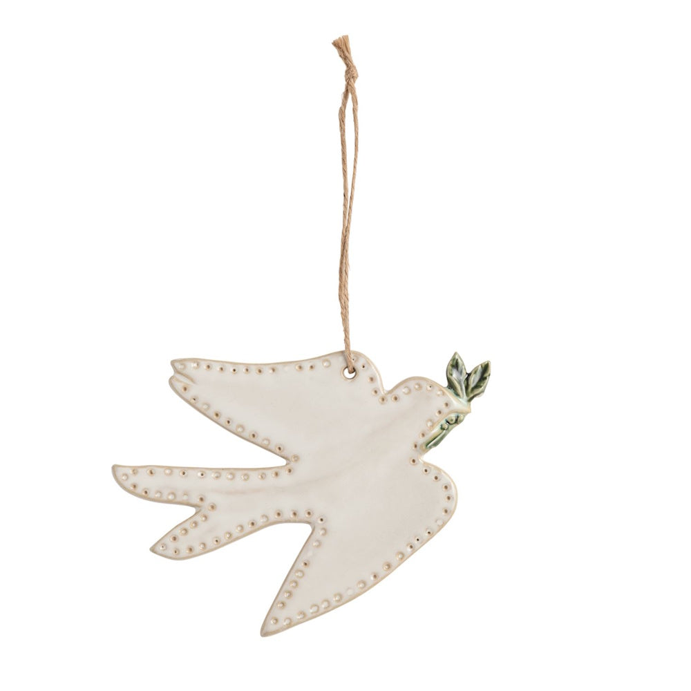 White ceramic turtle dove ornament carrying a green sprig, hanging by a twine string.