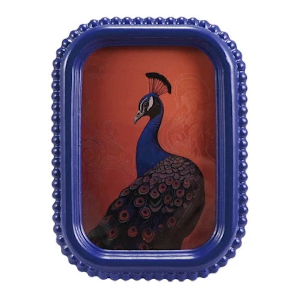 Blue beaded picture frame showcasing a peacock illustration with vibrant feathers on a warm red background.
