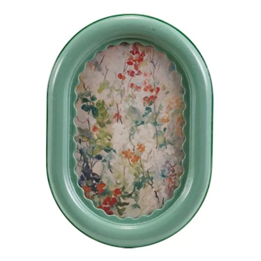 Oval mint green picture frame with a ruffled inner border and a vintage-style floral painting of red and white flowers.