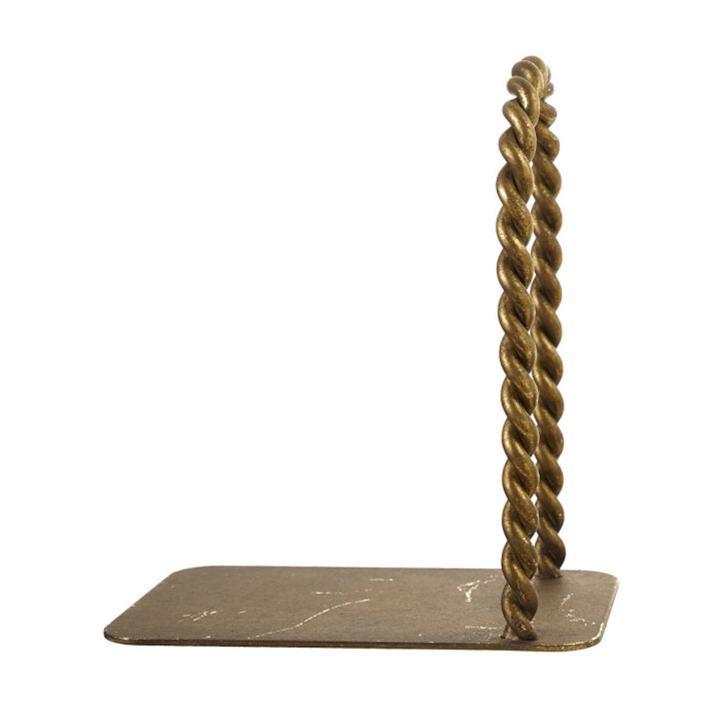 A brass-finished bookend featuring a flat base and a tall, vertical arch made of twisted metal.