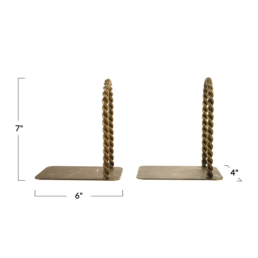 A pair of antique brass bookends with twisted metal arches, measuring 7 inches tall, 6 inches long, and 4 inches wide.