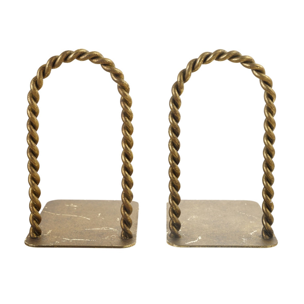 Two empty arched bookends made of twisted antique brass on flat bases on a white background.