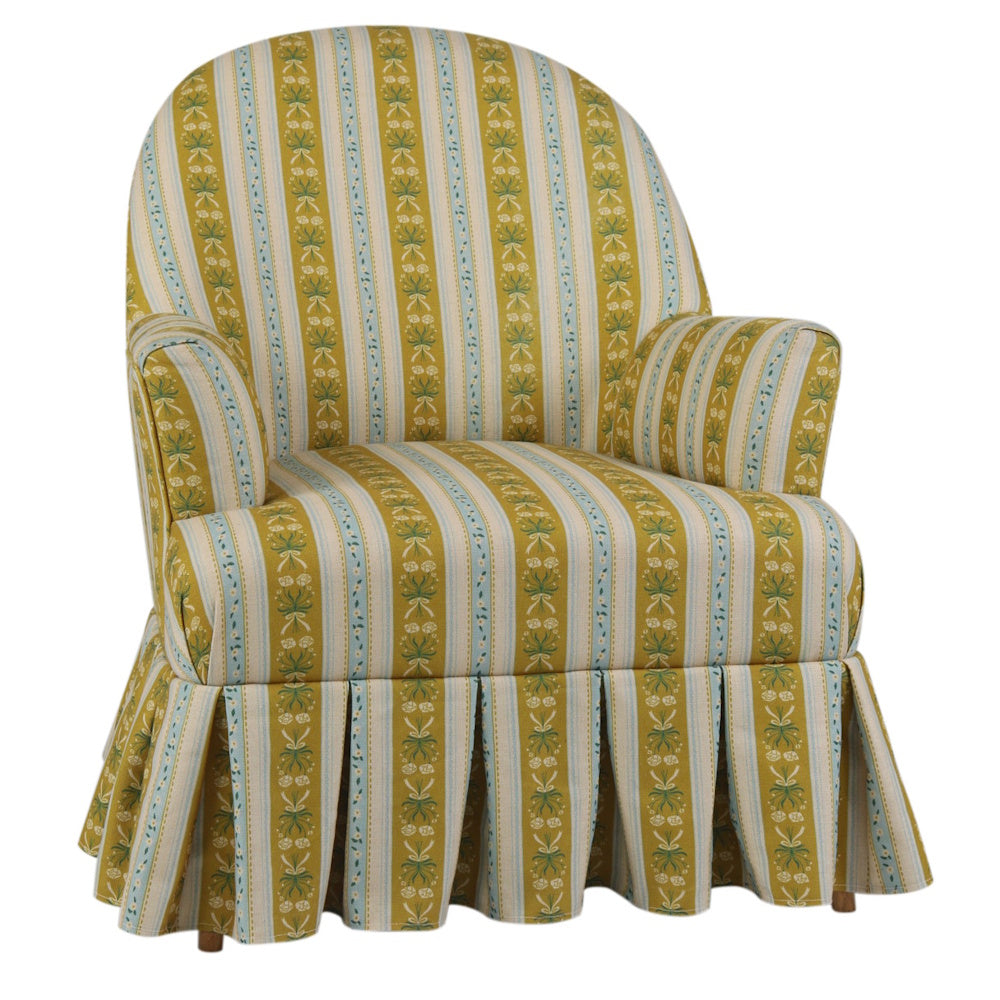 Upholstered yellow and blue striped armchair with box pleat skirt and piping trim.