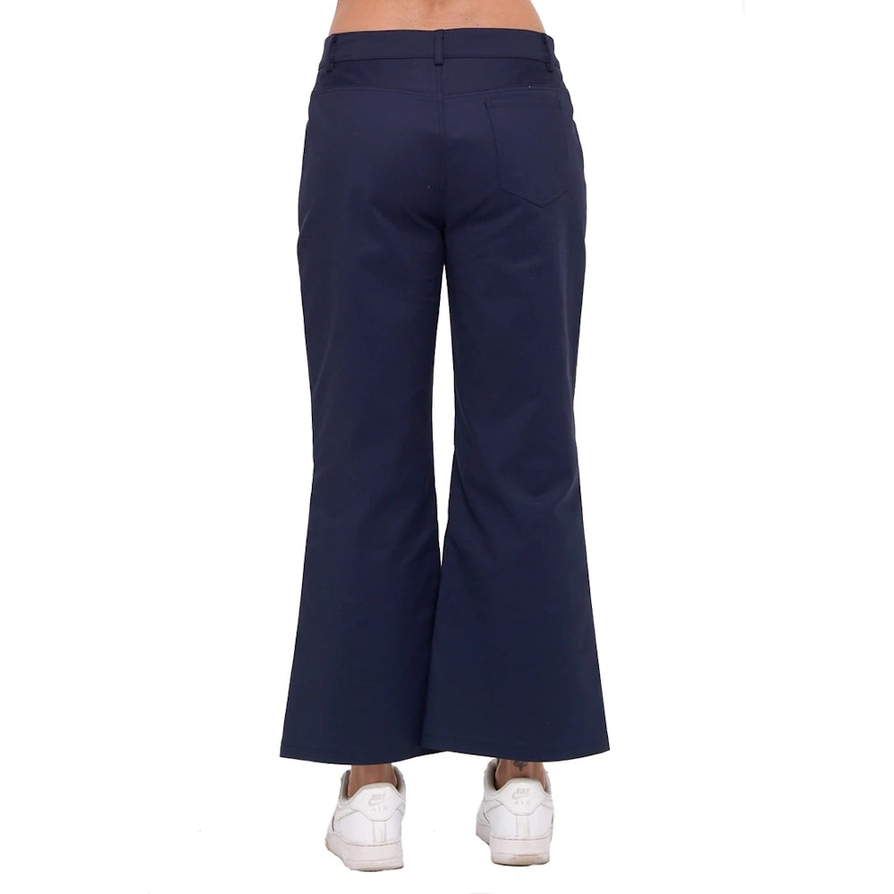 Back view of navy blue wide-leg ankle pants with a back pocket and belt loops, paired with white sneakers.